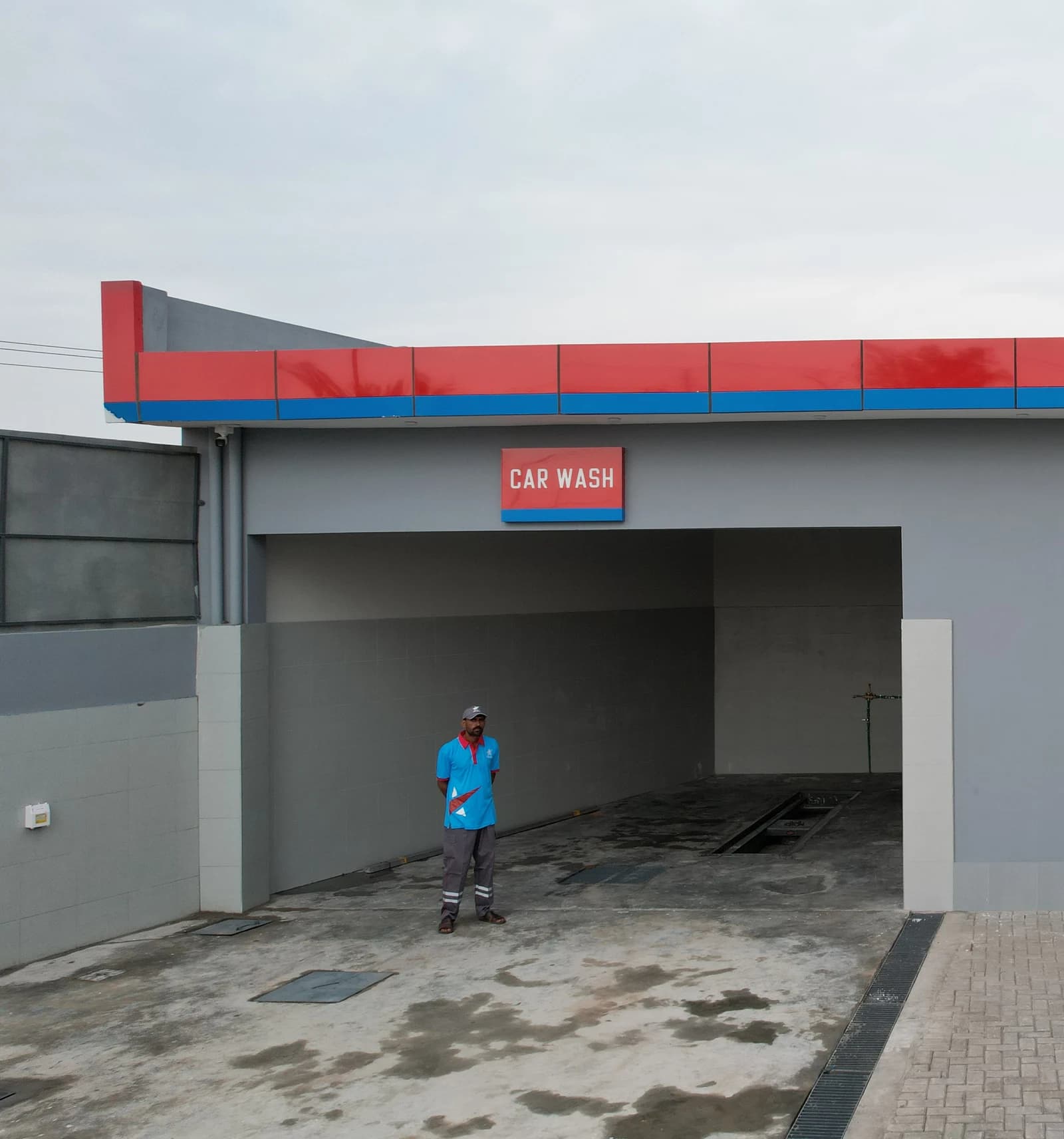Benzin Car Wash service bay with an attendant outside.