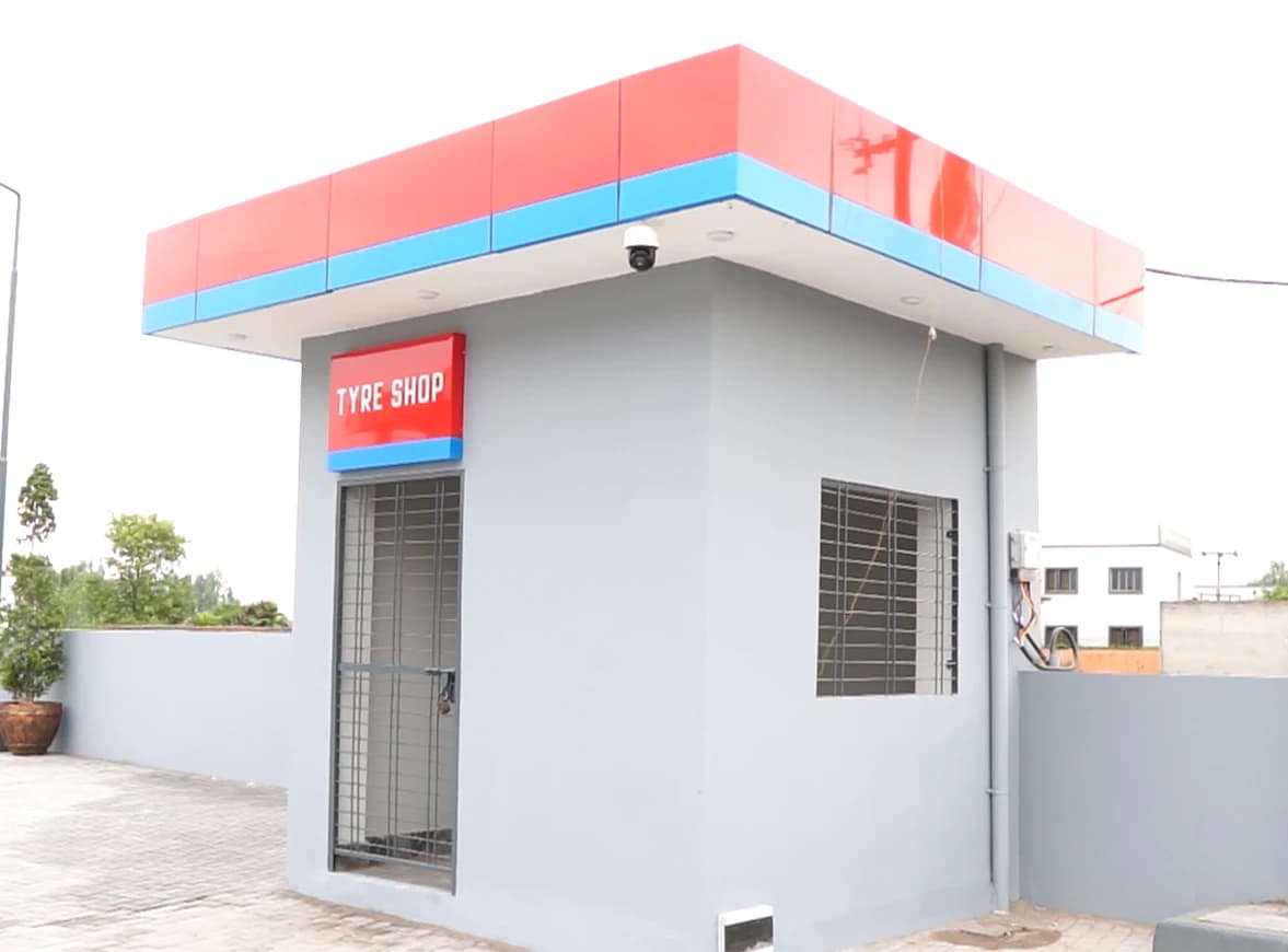 Benzin Tyre Shop building with red and blue signage.