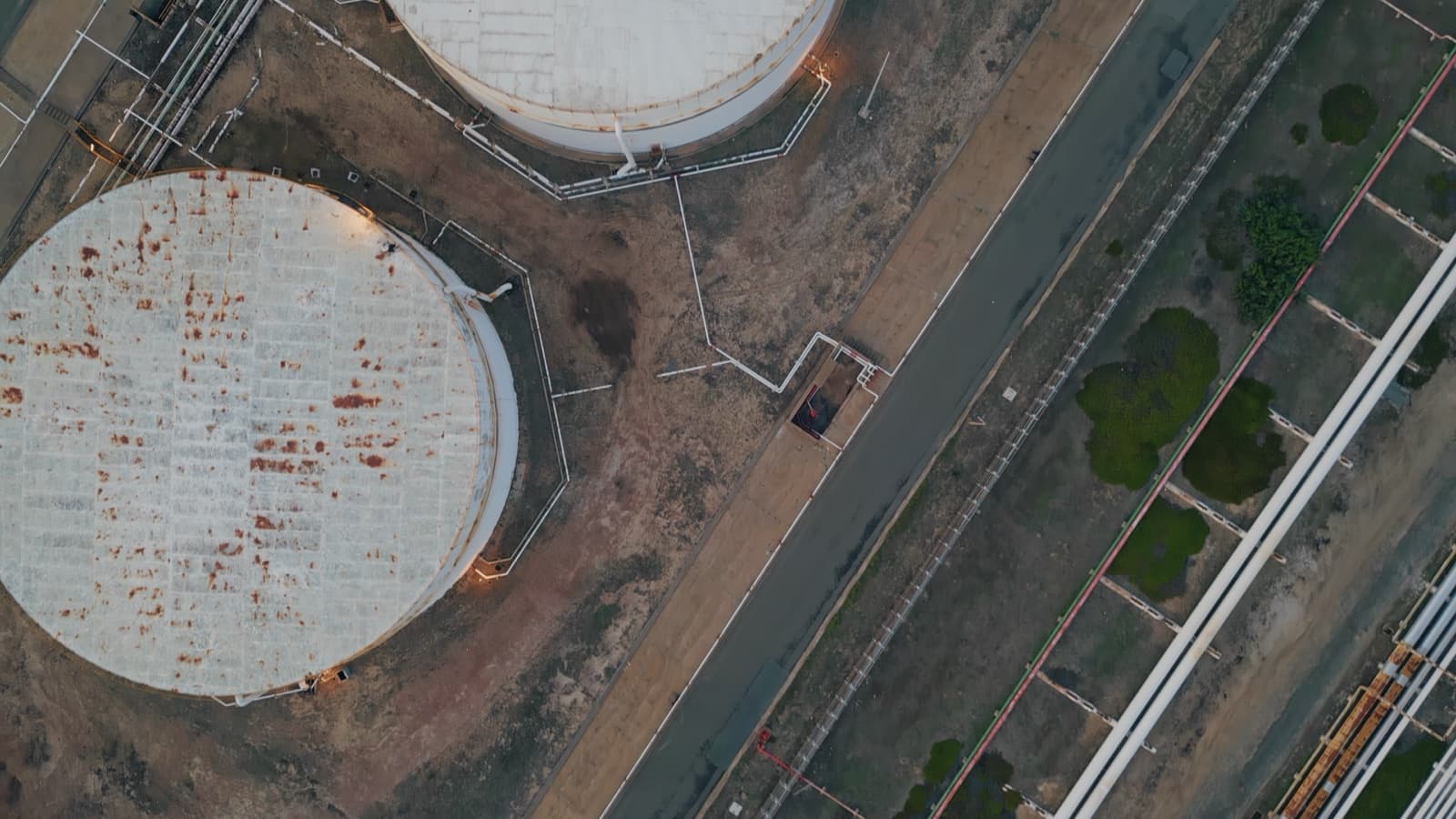 Aerial view of tank tops and pipework at a Benzin terminal